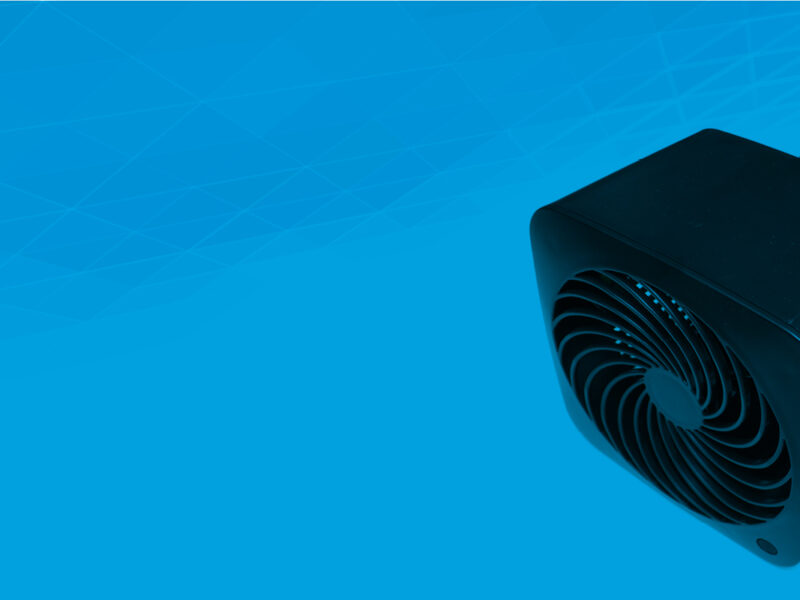 small black electric fan against blue background