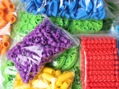 miscellaneous colorful plastic parts in clear plastic bags