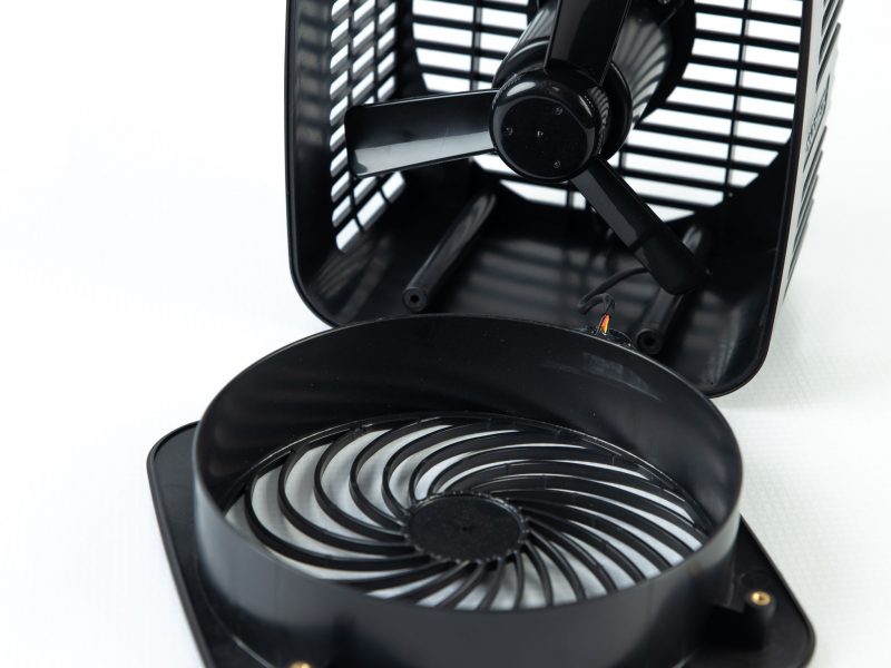 black plastic electric fan opened to view the inside