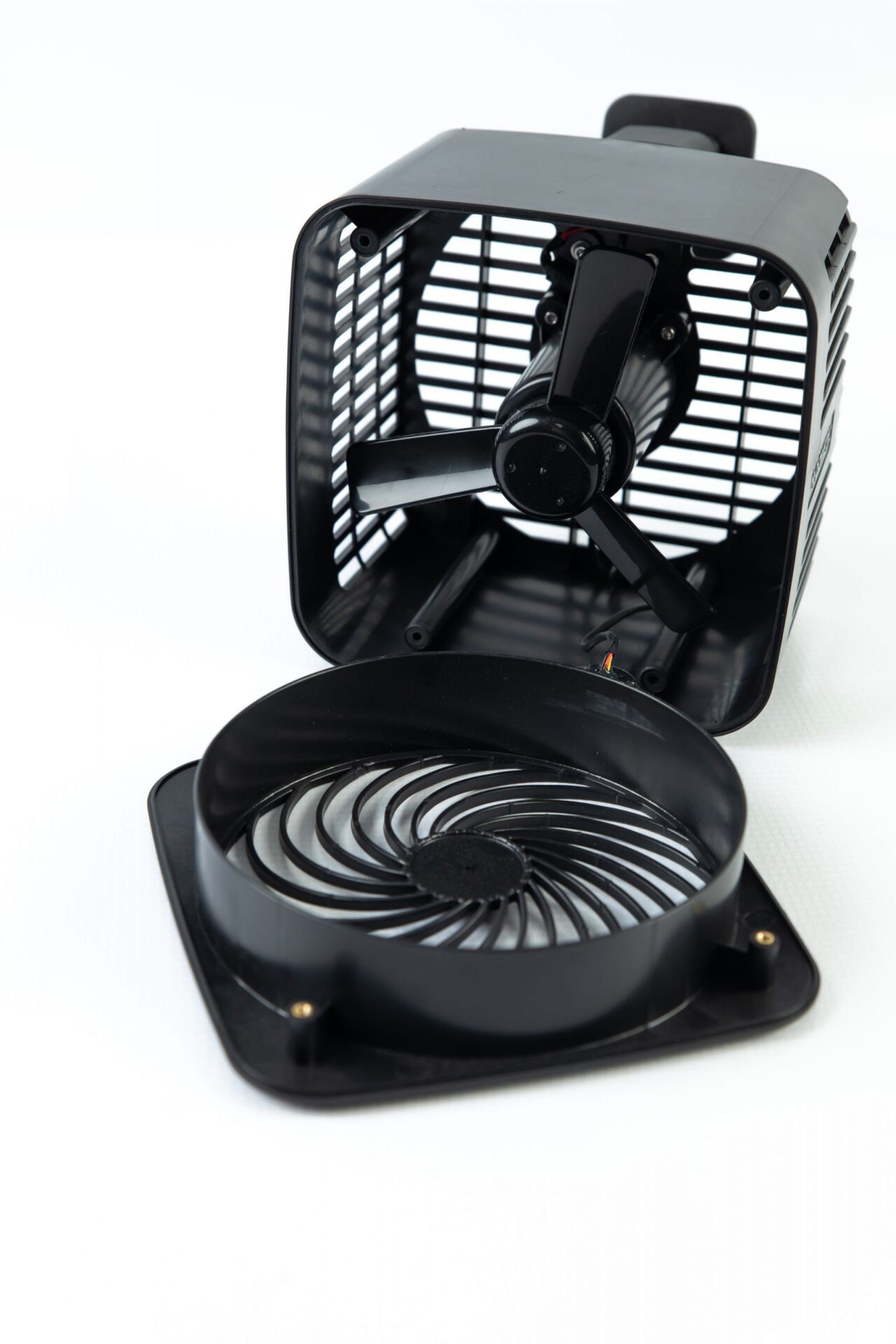 black plastic electric fan opened to view the inside