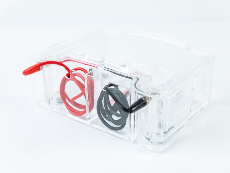 clear plastic piece with black and red wires